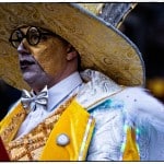 Person in ornate costume with large hat