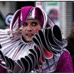 Person in colorful jester costume at festival