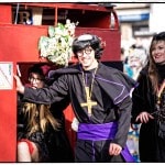 Costumed people enjoying outdoor parade event.