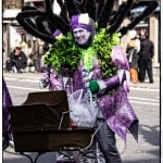Colorful street parade costume with stroller.