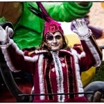Carnival performer in colorful costume waving