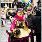 Colorful costume parade with vibrant attendees.