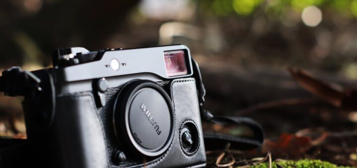 Selective Focus Photo of Black Fujifilm Camera on Ground