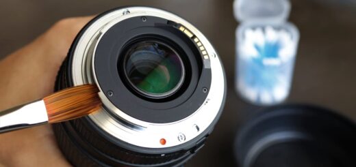 Person Cleaning Camera Lens