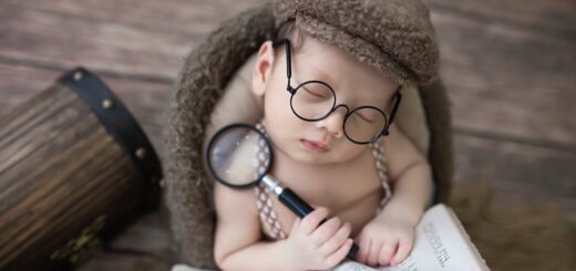 Close-Up Shot of a Baby Boy Holding a Magnifying Glass